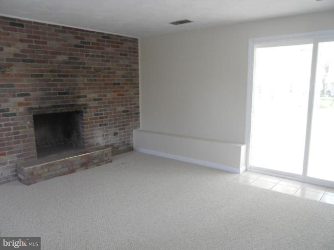 8820 Sigrid Road Randallstown, MD 21133 - Photo 12 of 23 a view of empty room with a fireplace
