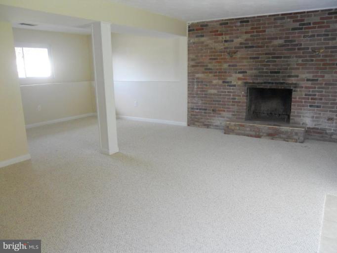 8820 Sigrid Road Randallstown, MD 21133 - Photo 13 of 23 a view of empty room with a fireplace