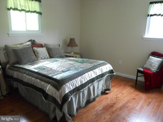 8820 Sigrid Road Randallstown, MD 21133 - Photo 20 of 23 a bedroom with a bed and wooden floor