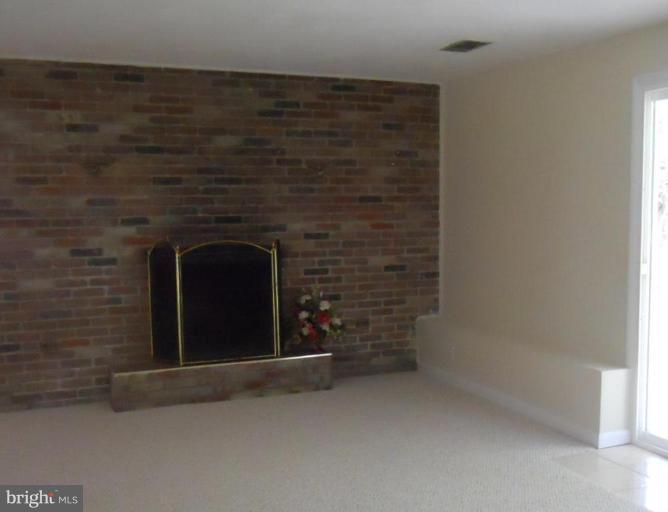 8820 Sigrid Road Randallstown, MD 21133 - Photo 22 of 23 a living room with a fireplace