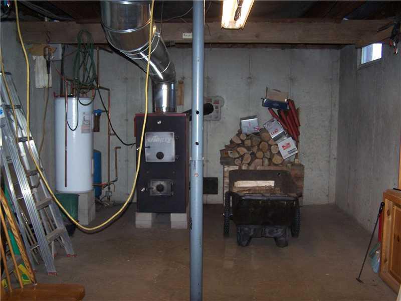 60 Estes Road Sumner, ME 04292 - Photo 11 of 15 Other. Basement showing the wood furnace