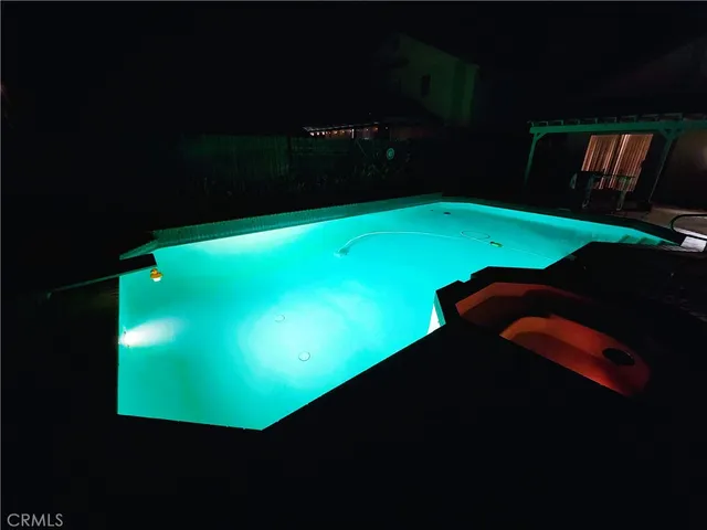 a view of a swimming pool with an outdoor space and seating area