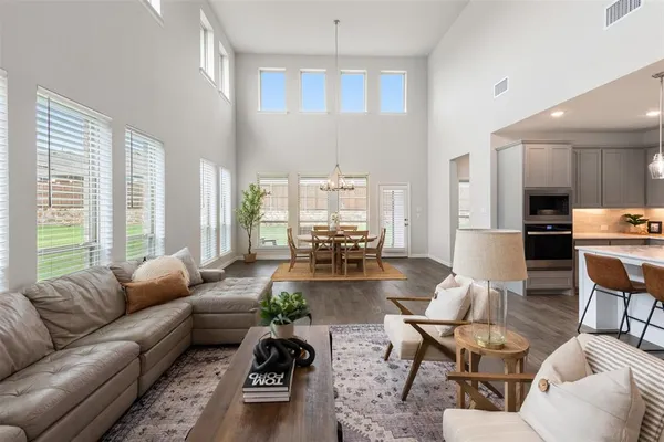 a living room with furniture fireplace and a large window