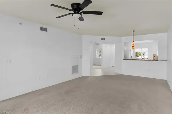 an empty room with a empty space and a ceiling fan