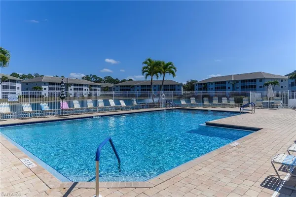 a view of swimming pool with outdoor seating and plants