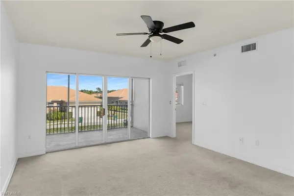 a view of a livingroom with a ceiling fan and window