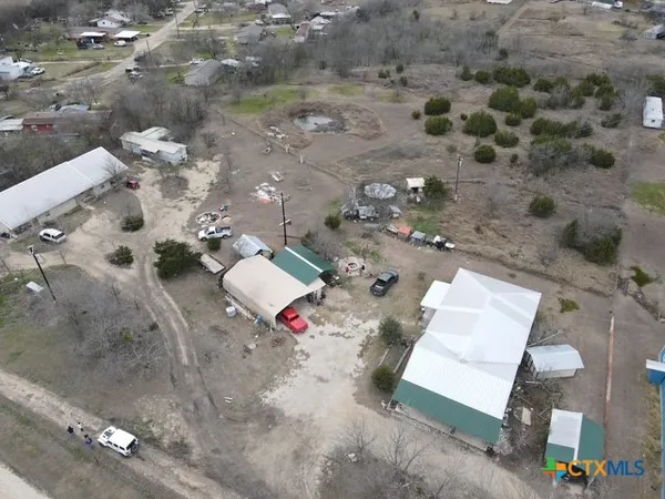 an aerial view of a house with a yard
