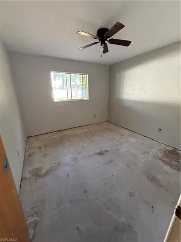 a view of an empty room and a window