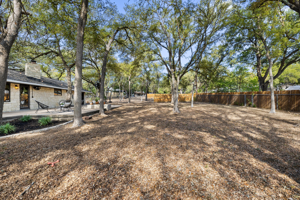 2008 Matthews Lane Austin, TX 78745 - Photo 33 of 36 The large backyard is shaded by old trees, and full of space to stretch, grill, or just hang out barefoot in the grass