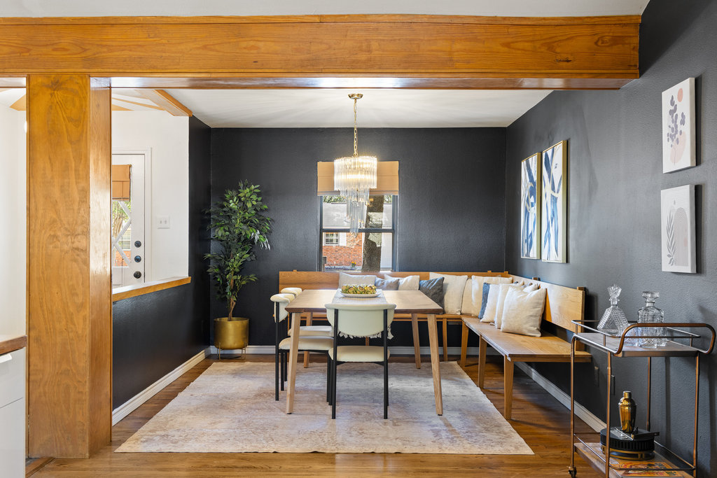 2008 Matthews Lane Austin, TX 78745 - Photo 4 of 36 The dining room wraps you in warmth with rich wood floors, a built-in bench that hugs the space, and a light fixture that makes every dinner feel a little more intentional