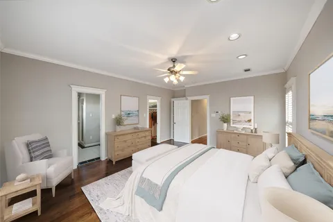 a spacious bedroom with a bed a couch and wooden floor