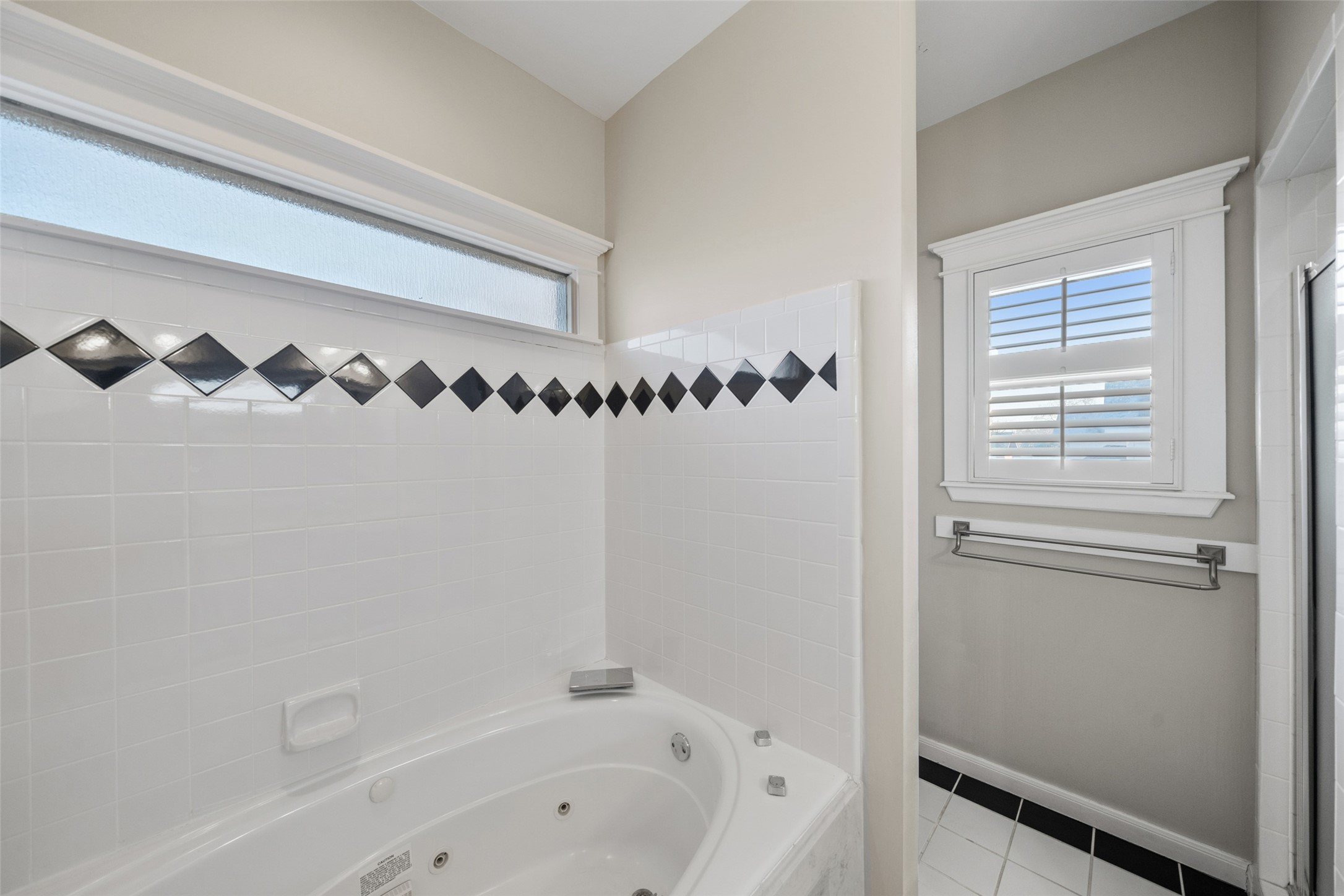 1342 Allston Street Houston, TX 77008 - Photo 24 of 39 Oversized soaking tub positioned beneath a frosted transom window for privacy and natural light.