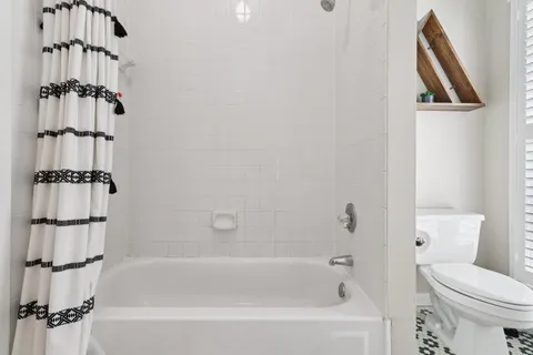 a bathroom with a shower sink and mirror