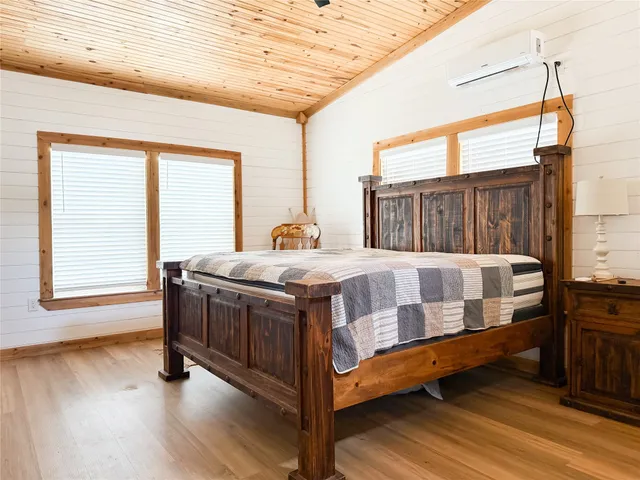 a bedroom with furniture window and wooden floor