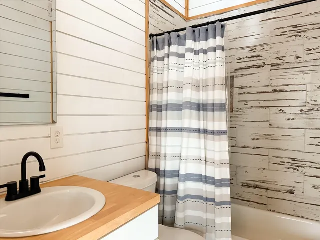 a bathroom with a shower and a sink