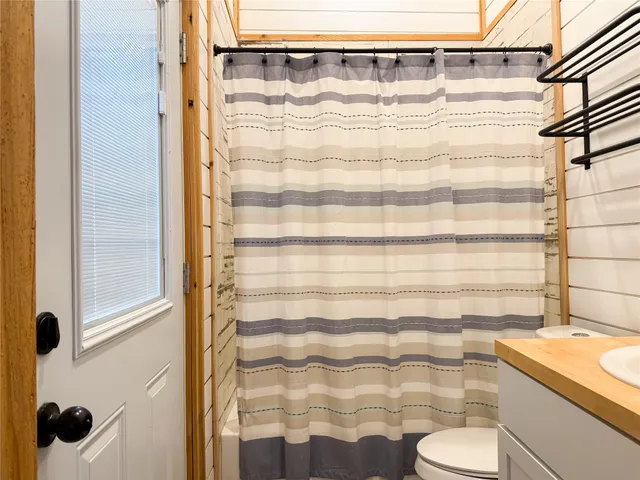 a bathroom with a shower curtain and a sink
