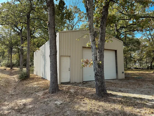 a view of a house with a tree in the background