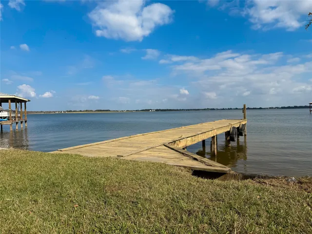 a view of a lake with houses in the background
