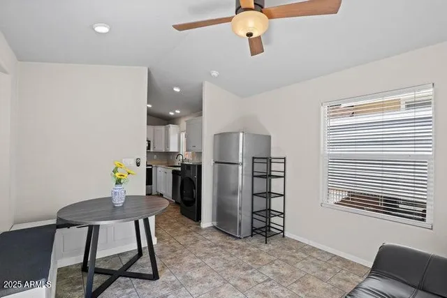 a view of a workspace with furniture and a window