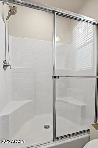 a bathroom with a glass shower door