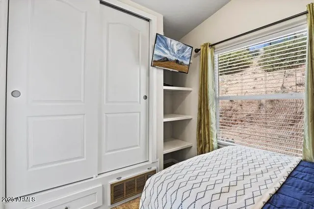 a bedroom with a bed and a walk in closet