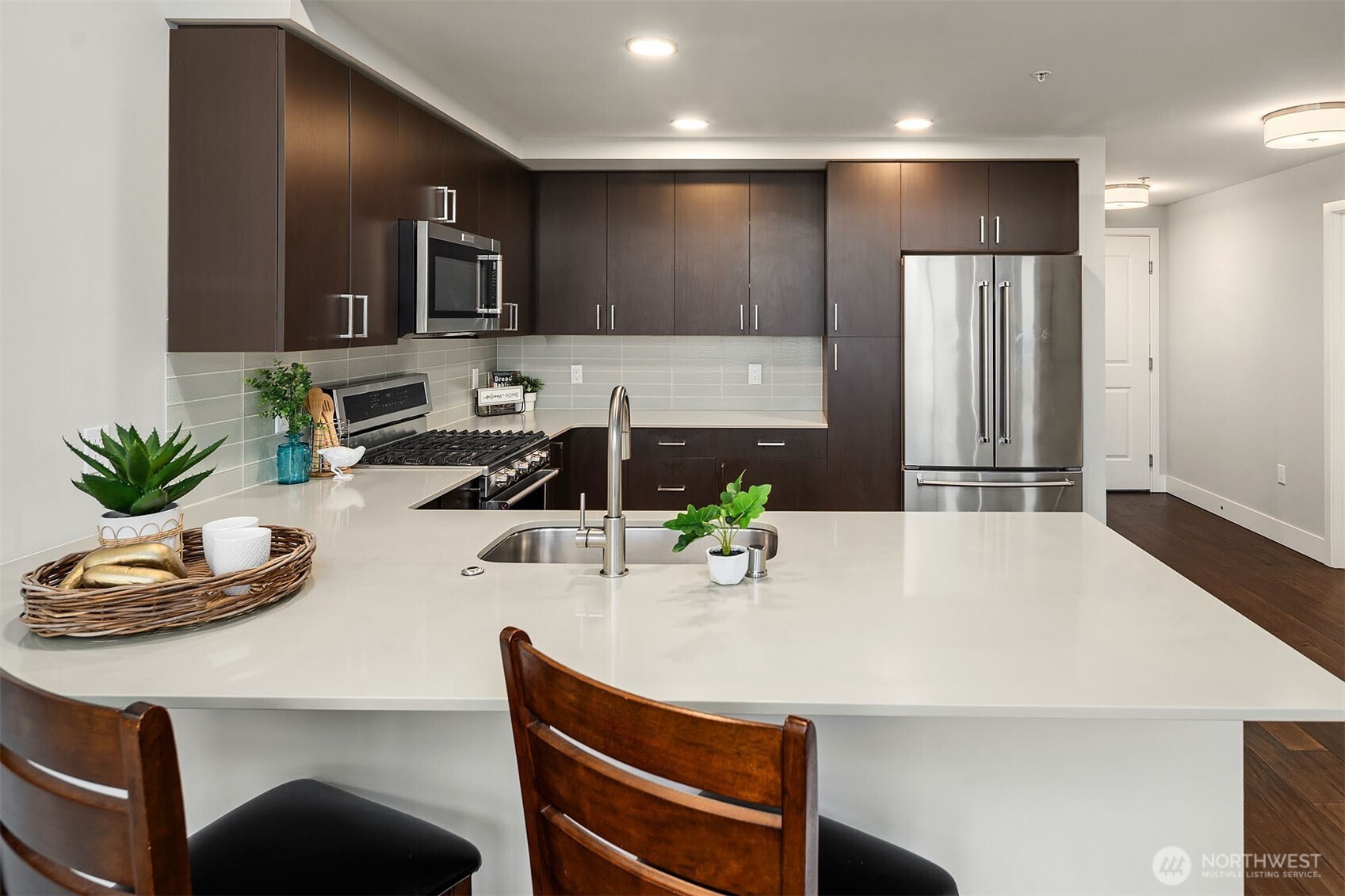 50 Pine Street, Unit 404 Edmonds, WA 98020 - Photo 12 of 33 a kitchen with a refrigerator and a sink