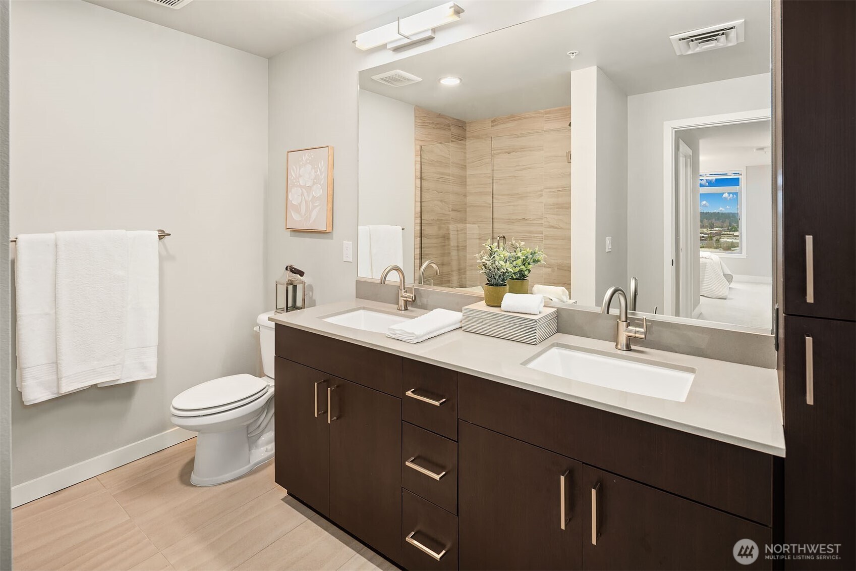 50 Pine Street, Unit 404 Edmonds, WA 98020 - Photo 19 of 33 a bathroom with a double vanity sink toilet and a mirror