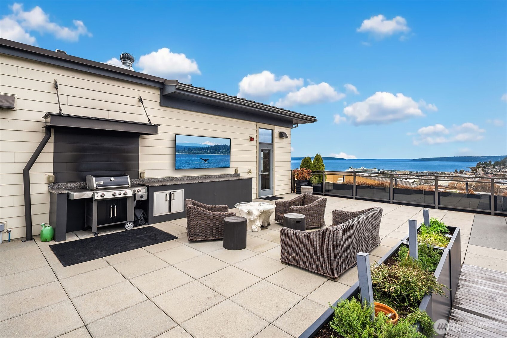 50 Pine Street, Unit 404 Edmonds, WA 98020 - Photo 27 of 33 a living room with couches a flat screen tv and kitchen view