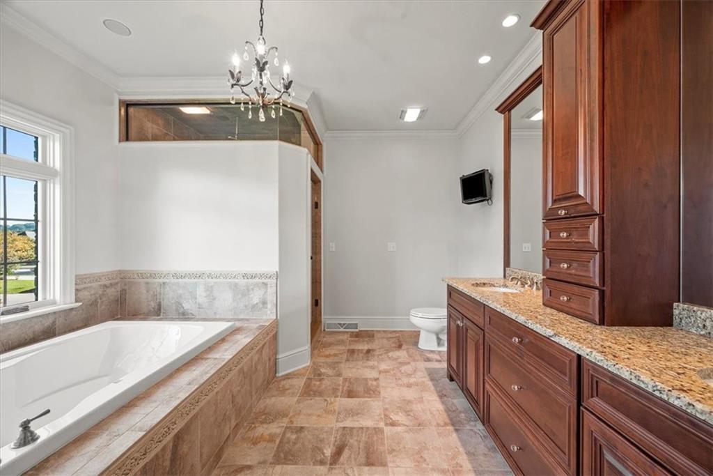 312 Cambridge Drive Mars, PA 16046 - Photo 22 of 50 a spacious bathroom with a granite countertop sink a large mirror and a bathtub