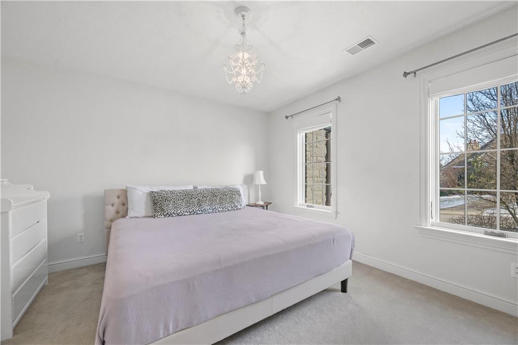 312 Cambridge Drive Mars, PA 16046 - Photo 26 of 50 a bedroom with a large bed and a chandelier