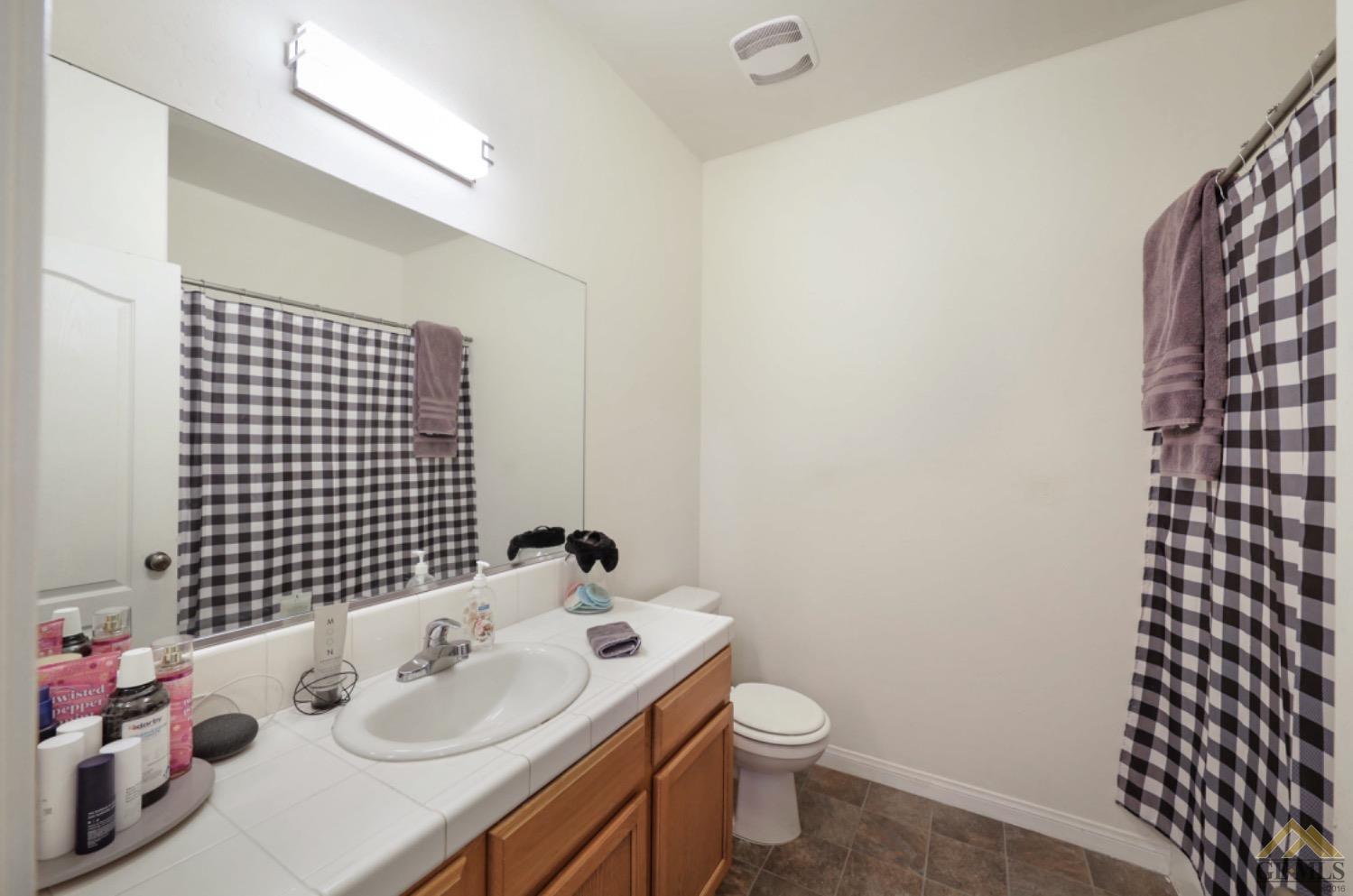 Undisclosed Address Bakersfield, CA 93306 - Photo 11 of 29 a bathroom with a sink toilet and shower