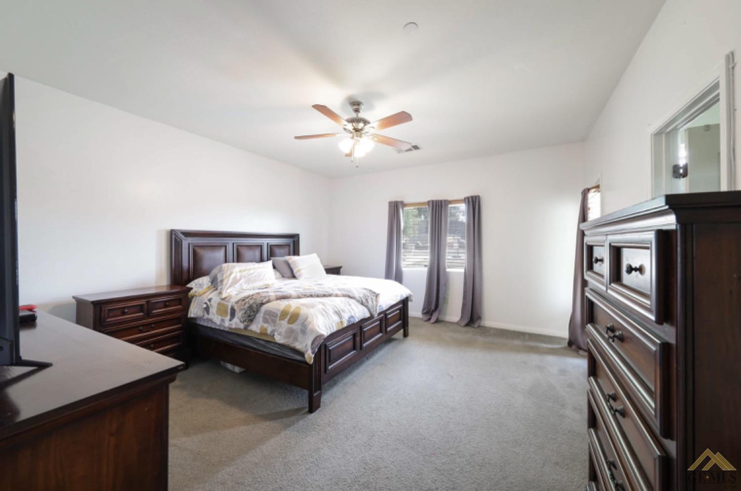 Undisclosed Address Bakersfield, CA 93306 - Photo 13 of 29 a bedroom with a bed and a chandelier