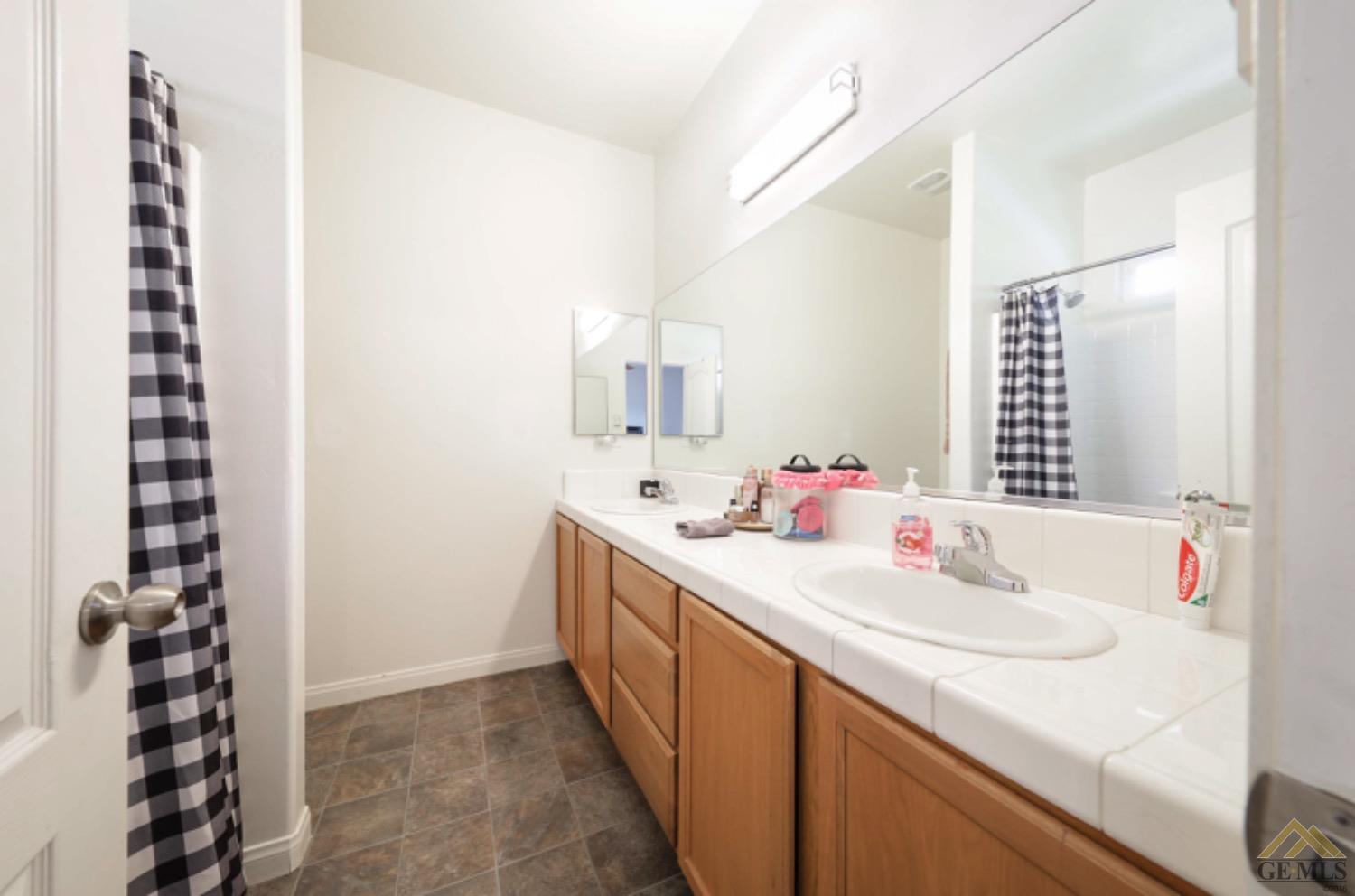 Undisclosed Address Bakersfield, CA 93306 - Photo 14 of 29 a bathroom with a sink and a mirror