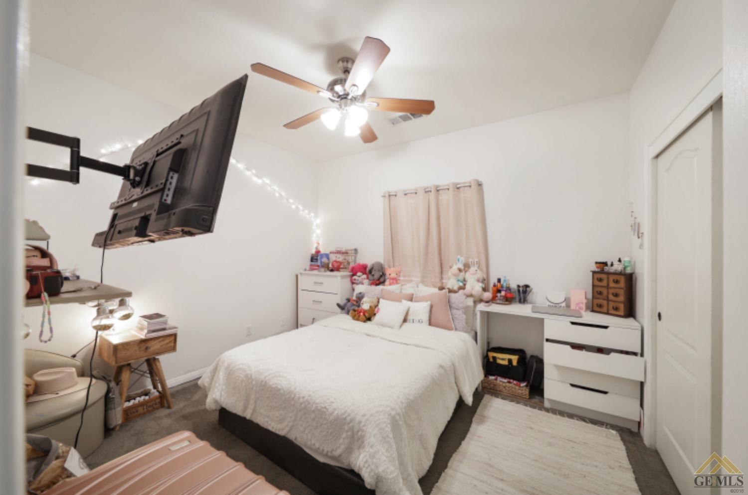 Undisclosed Address Bakersfield, CA 93306 - Photo 18 of 29 a bedroom with a bed and a chandelier