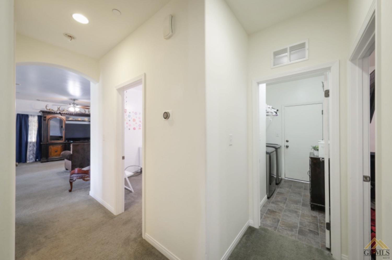 Undisclosed Address Bakersfield, CA 93306 - Photo 19 of 29 a view of a hallway with closet and a livingroom