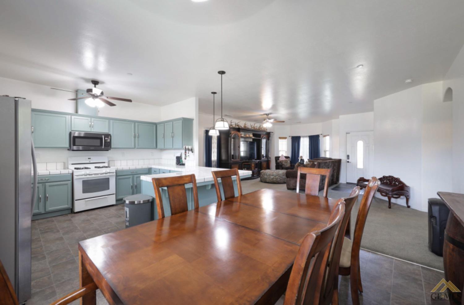 Undisclosed Address Bakersfield, CA 93306 - Photo 20 of 29 a large kitchen with a table and chairs