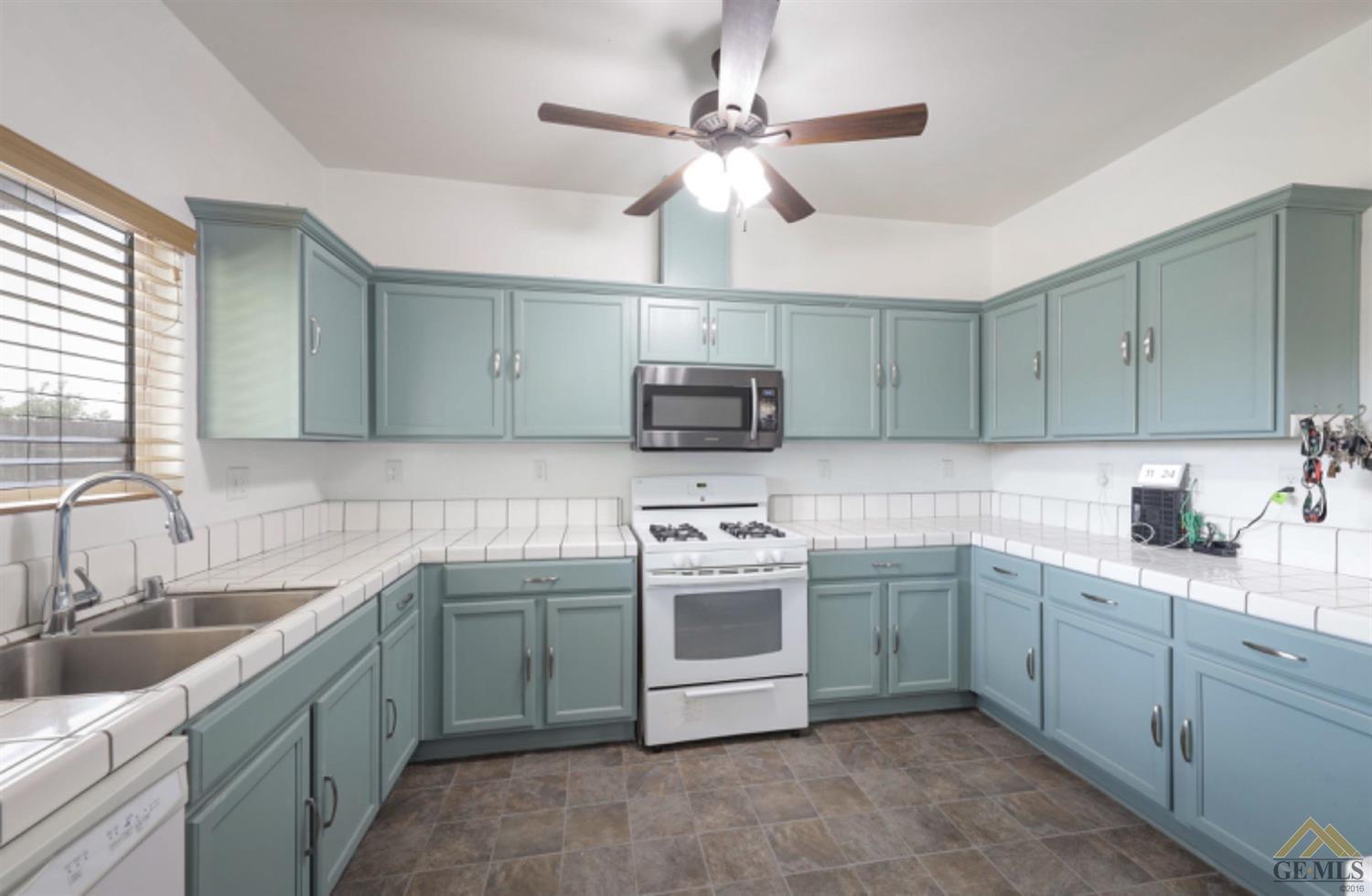Undisclosed Address Bakersfield, CA 93306 - Photo 21 of 29 a kitchen with a sink stove and microwave