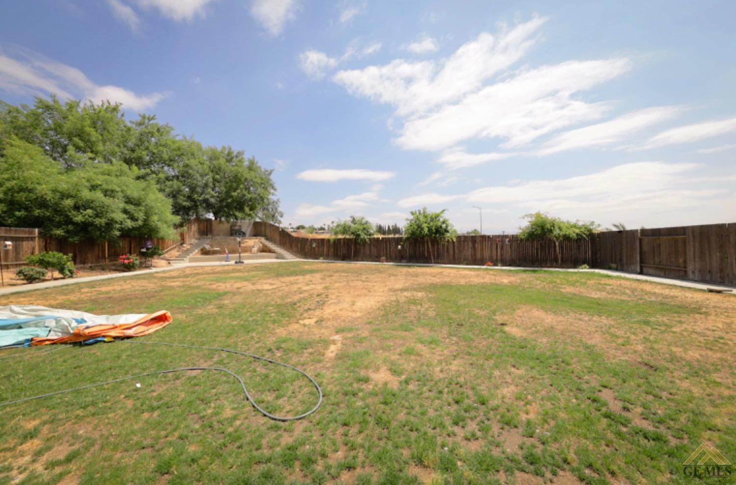 Undisclosed Address Bakersfield, CA 93306 - Photo 25 of 29 a view of yard with swimming pool and green space