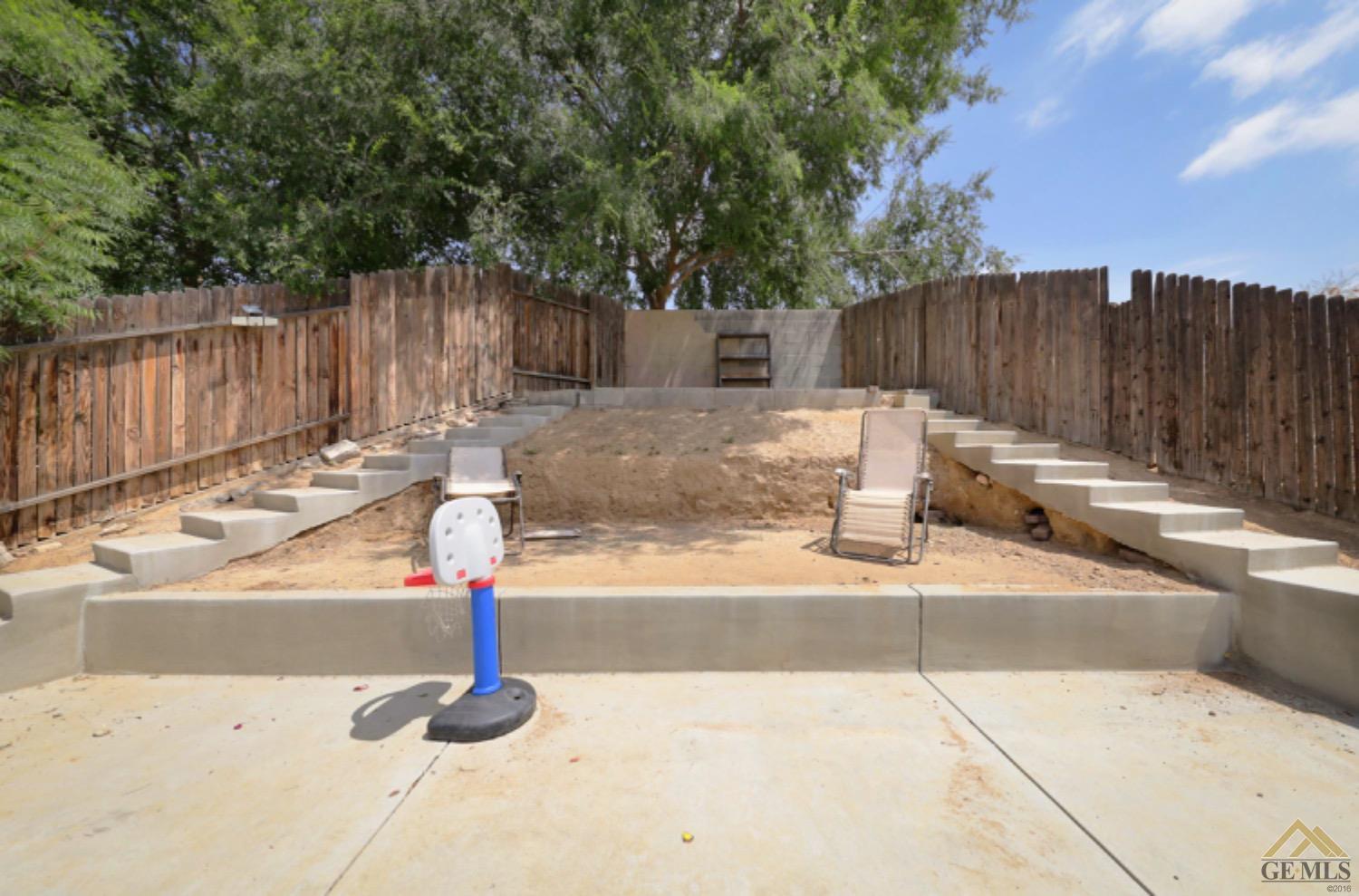 Undisclosed Address Bakersfield, CA 93306 - Photo 27 of 29 a backyard of a house with table and chairs