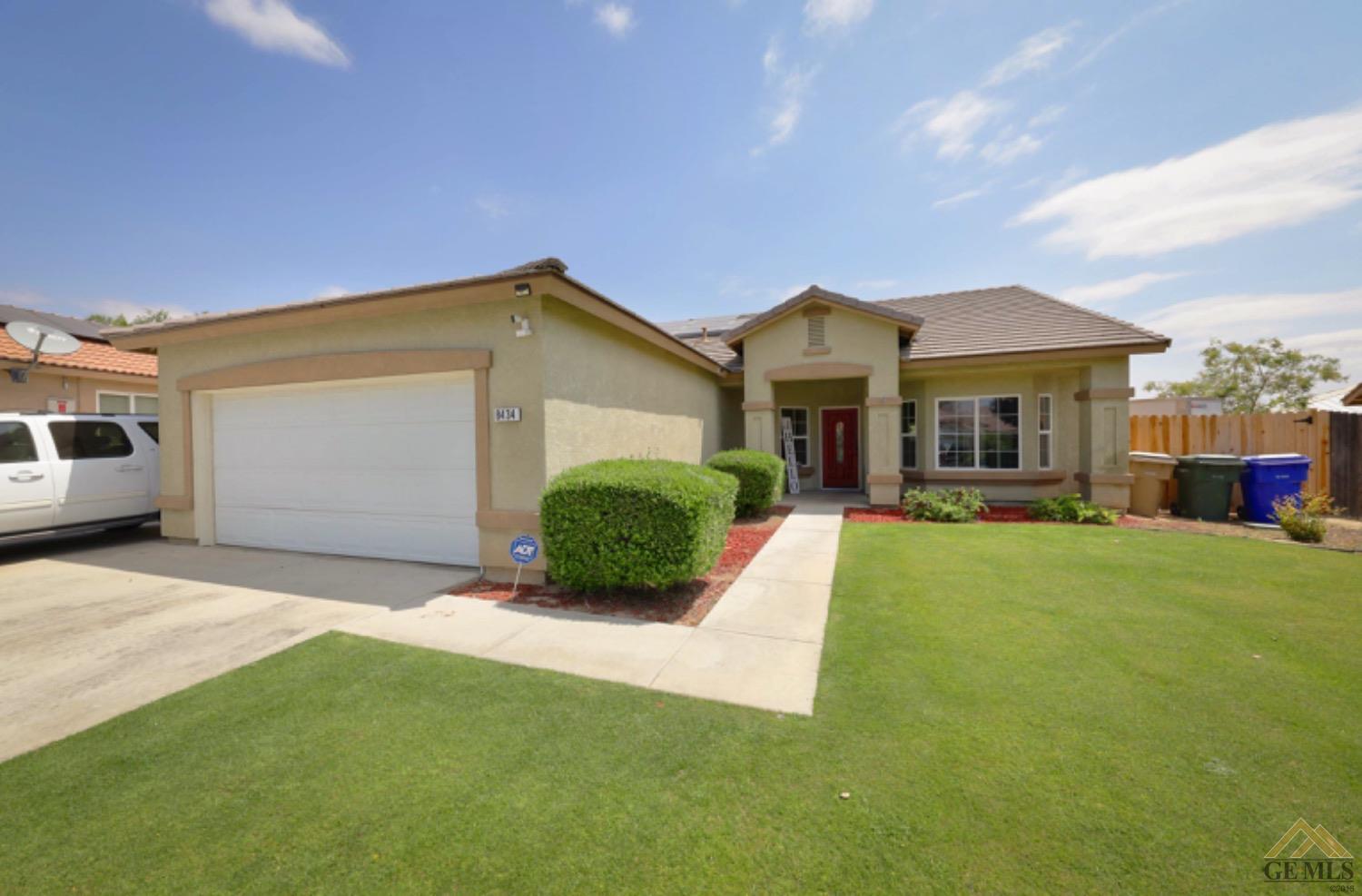 Undisclosed Address Bakersfield, CA 93306 - Photo 4 of 29 a front view of a house with a yard and garage