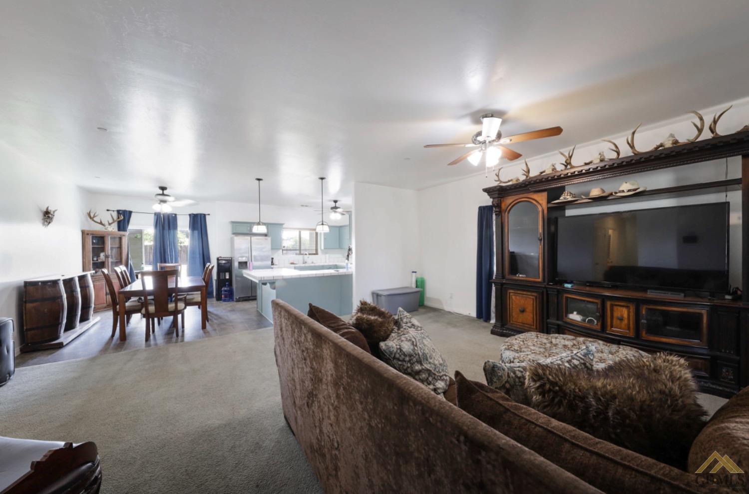 Undisclosed Address Bakersfield, CA 93306 - Photo 6 of 29 a living room with furniture and a flat screen tv