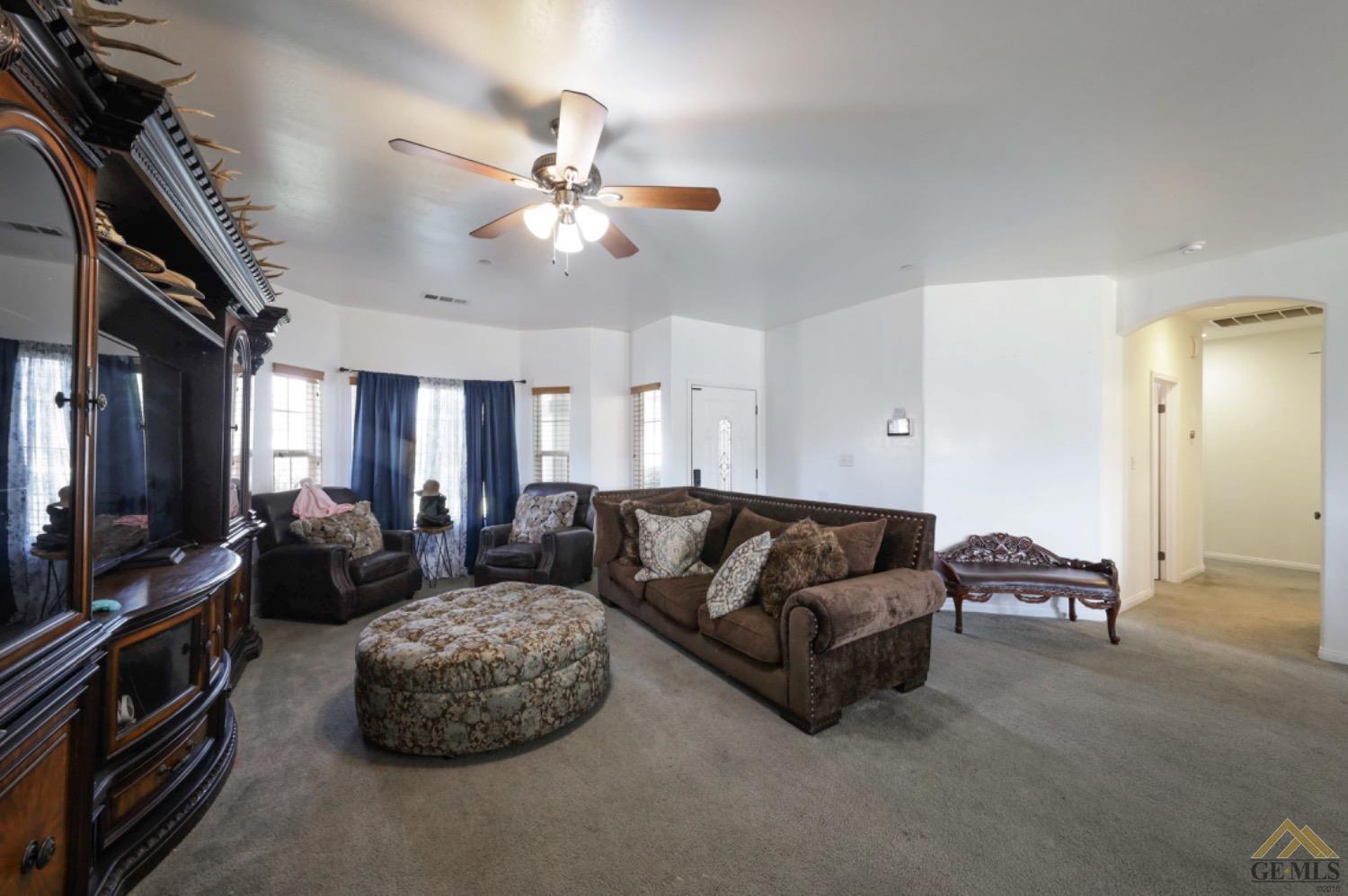Undisclosed Address Bakersfield, CA 93306 - Photo 8 of 29 a living room with furniture and a flat screen tv