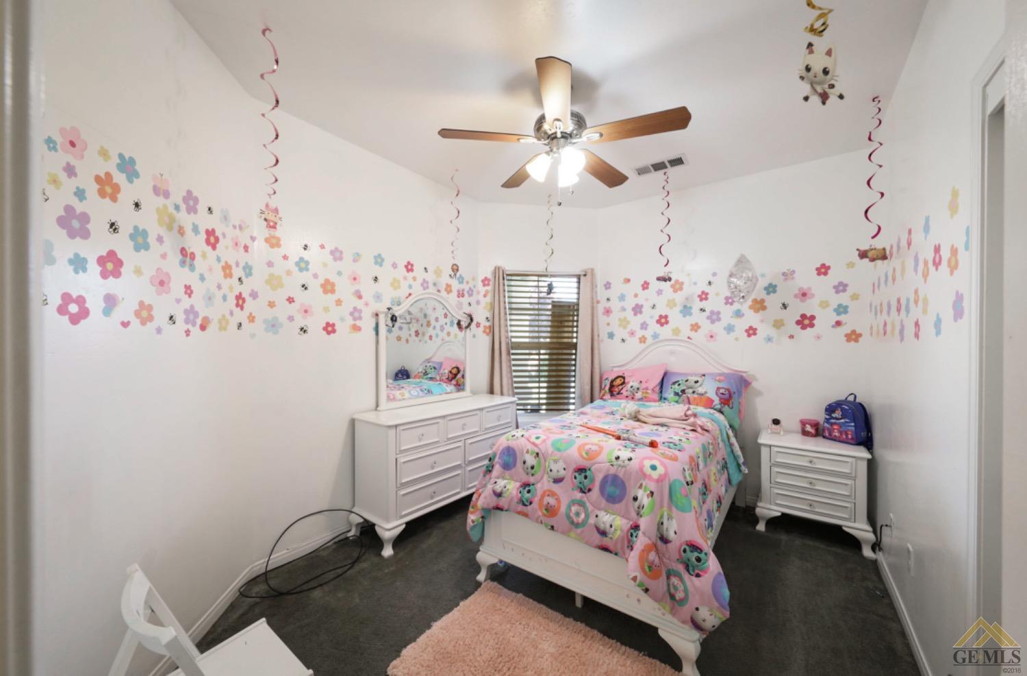 Undisclosed Address Bakersfield, CA 93306 - Photo 10 of 29 a bedroom with a bed and a chandelier