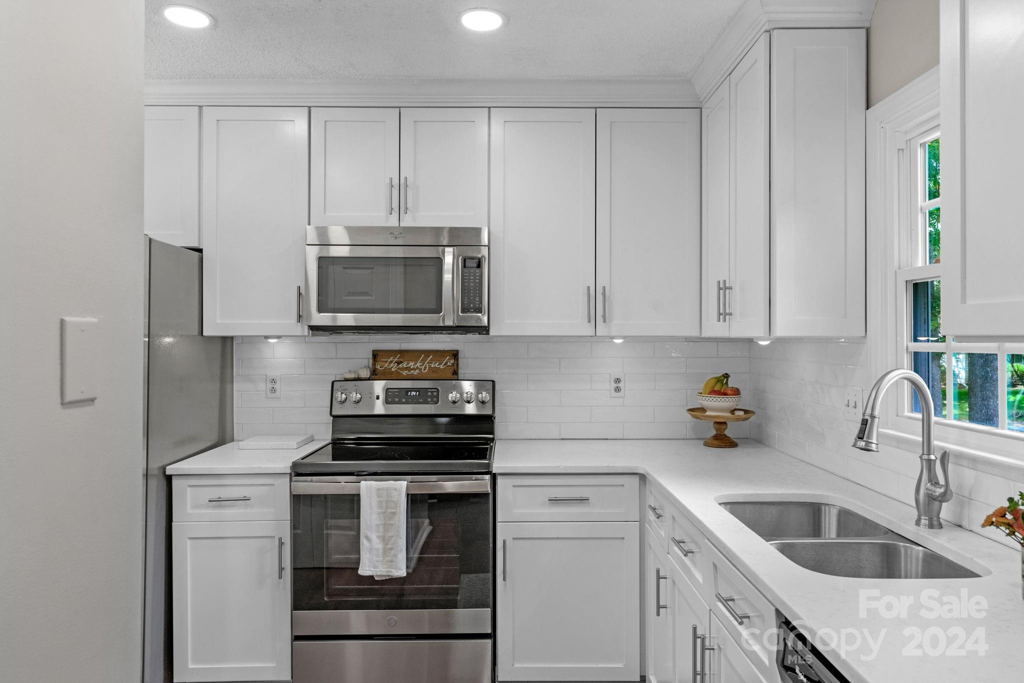 406 Sandymead Road Matthews, NC 28105 - Photo 16 of 48 a kitchen with appliances a sink and cabinets