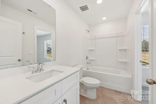 a bathroom with a sink toilet a shower and a mirror