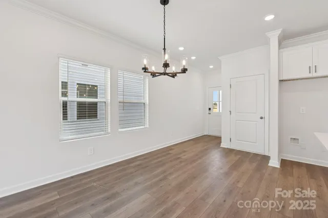 a view of a livingroom with a ceiling fan window and wooden floor