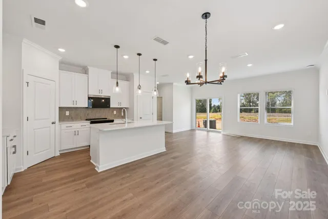 a view of kitchen with cabinets and wooden floor
