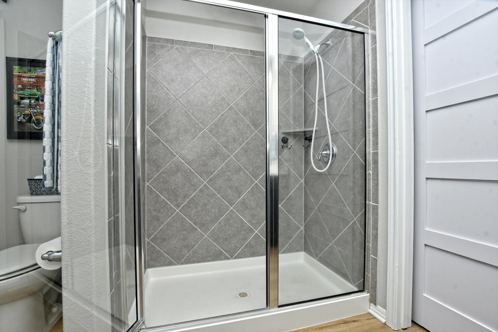 231 Hobby Street Georgetown, TX 78633 - Photo 21 of 29 A chic, tile-accented shower with a glass enclosure for a refreshing bathroom retreat.