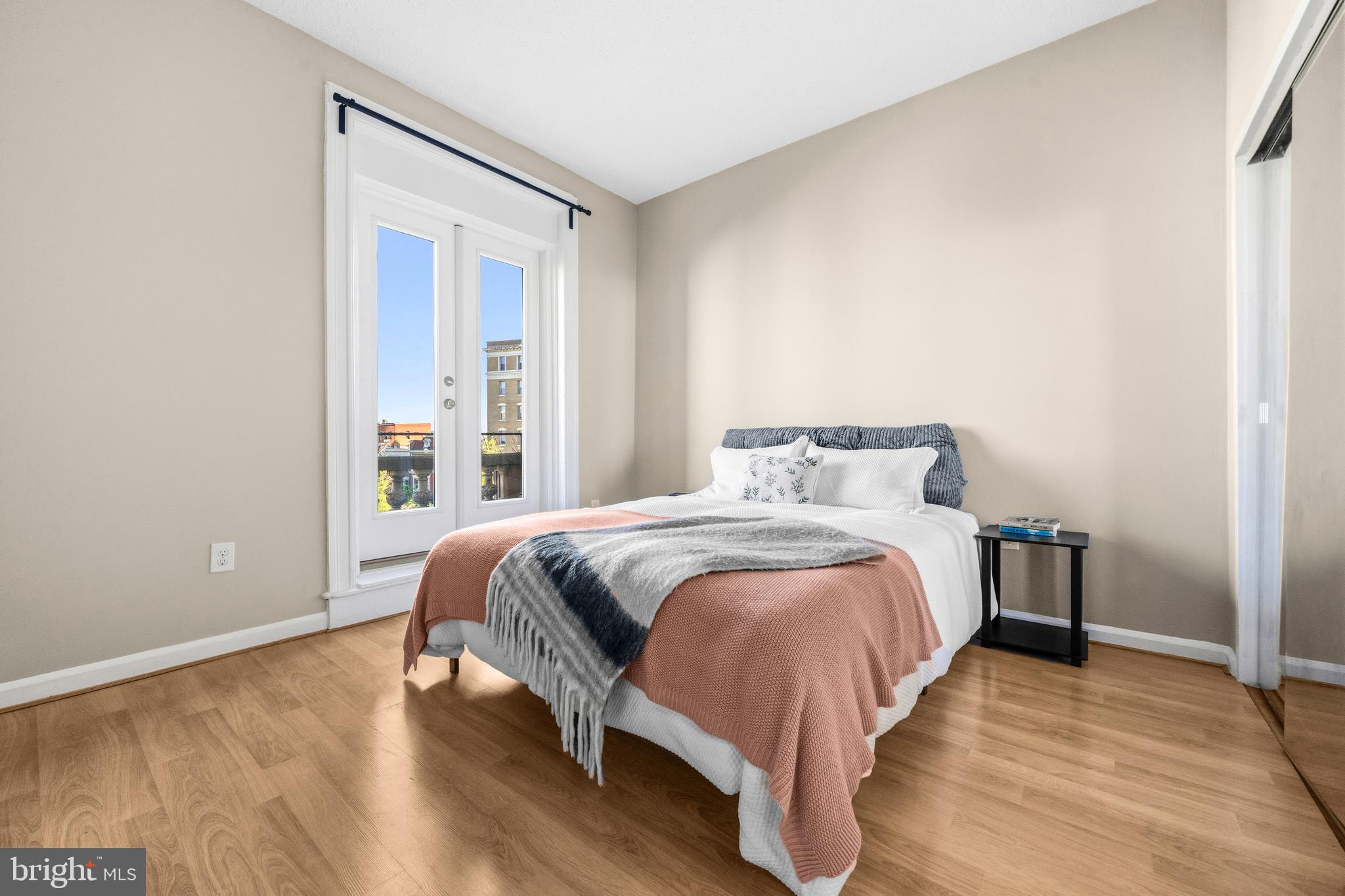 1851 Columbia Road Northwest, Unit 401 Washington, DC 20009 - Photo 15 of 27 a bedroom with a bed and wooden floor