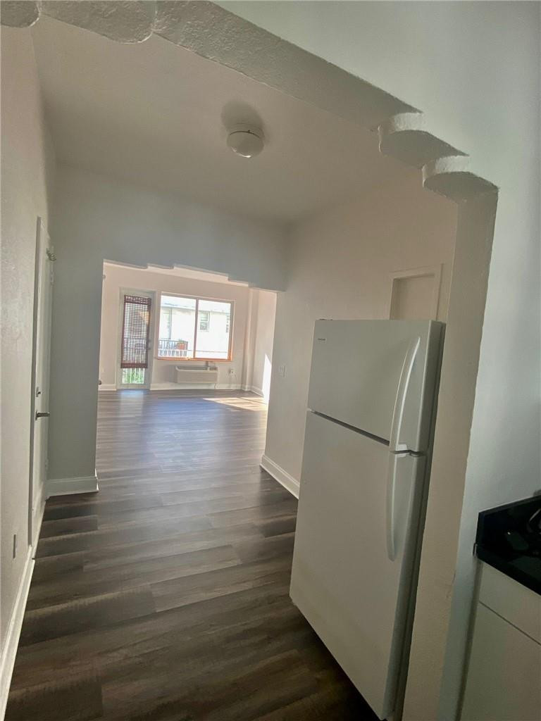 320 80th Street, Unit 15 Miami Beach, FL 33141 - Photo 4 of 18 a view of empty room with wooden floor and electronic appliances